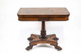 A William IV rosewood card table, the wasted rectangular base on four carved paw feet,