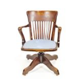 A mixed hardwood tilt/swivel/raising Captain's chair with deep back top rail over squared back rods