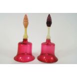 Two Victorian glass bells, each with cranberry tinted bodies,