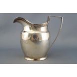 A silver cream jug, of plain bellied oval form with reeded edging, London 1799, 10cm high,