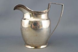 A silver cream jug, of plain bellied oval form with reeded edging, London 1799, 10cm high,