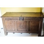 A 17th century oak coffer with triple panelled front and carved frieze,