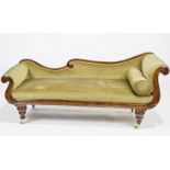 A mahogany double scroll end asymmetric late Regency sofa with back rail and worked front raised on