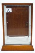 A mahogany small shop display cabinet with glazed sides and top and a solid locking door,
