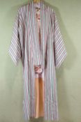 A pink and grey striped Kimono with pink flower decorated robe,