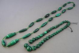 A collection of two strung malachite/beaded necklaces.