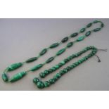 A collection of two strung malachite/beaded necklaces.