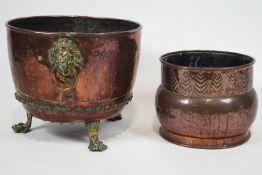 A copper coal bucket with brass lion mask ring handles and brass lion paw feet,