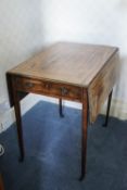 A 19th century mahogany Pembroke table on square tapering legs with brass casters,