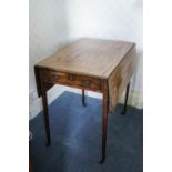 A 19th century mahogany Pembroke table on square tapering legs with brass casters,