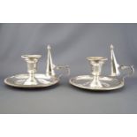 A pair of silver plated chamber sticks, of traditional form with rope work edging,
