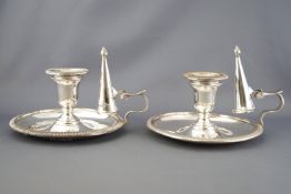 A pair of silver plated chamber sticks, of traditional form with rope work edging,