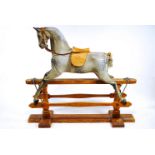 An early 20th Century carved and painted rocking horse by F H Ayres, with ivorine Hamleys lable,