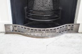 A George III serpentine steel fender,