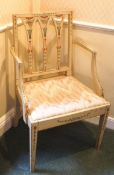 An early 19th century painted elbow chair with drop in seat on square tapering legs