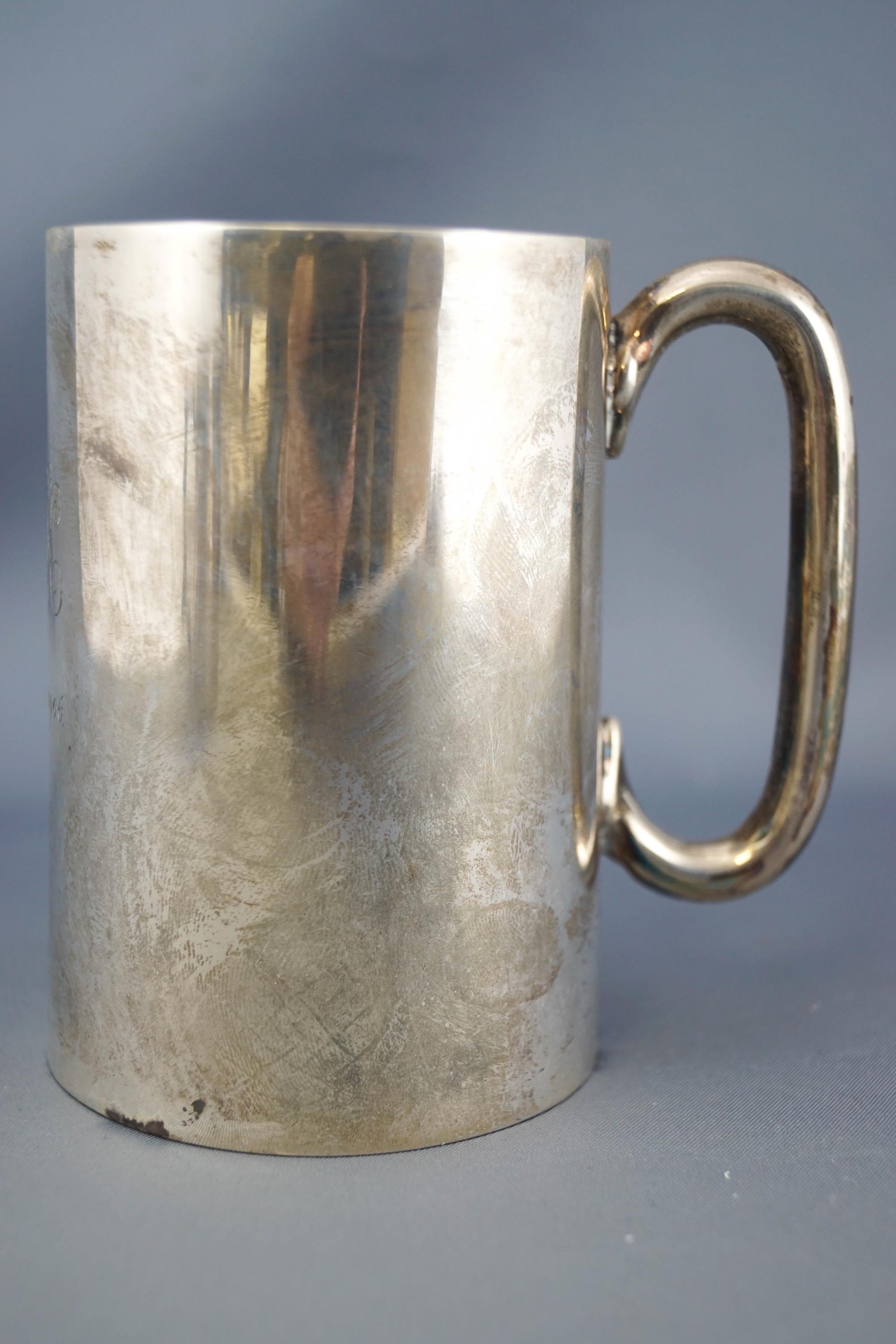 A silver mug, of plain tapering form, set with a cylindrical C handle, Sheffield 1904, 10cm high,