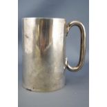 A silver mug, of plain tapering form, set with a cylindrical C handle, Sheffield 1904, 10cm high,