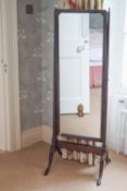 A mahogany cheval mirror on cabriole legs,