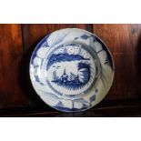 An 18th century English Delft plate, painted with landscape,