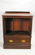 A mahogany open cabinet with one frieze drawer on plinth base,