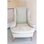 A wing armchair on cabriole legs,