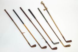 A group of hickory golf clubs,