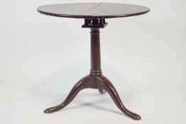 A George III tripod table with birdcage structure,