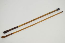 A pair of canes with leather covered tops