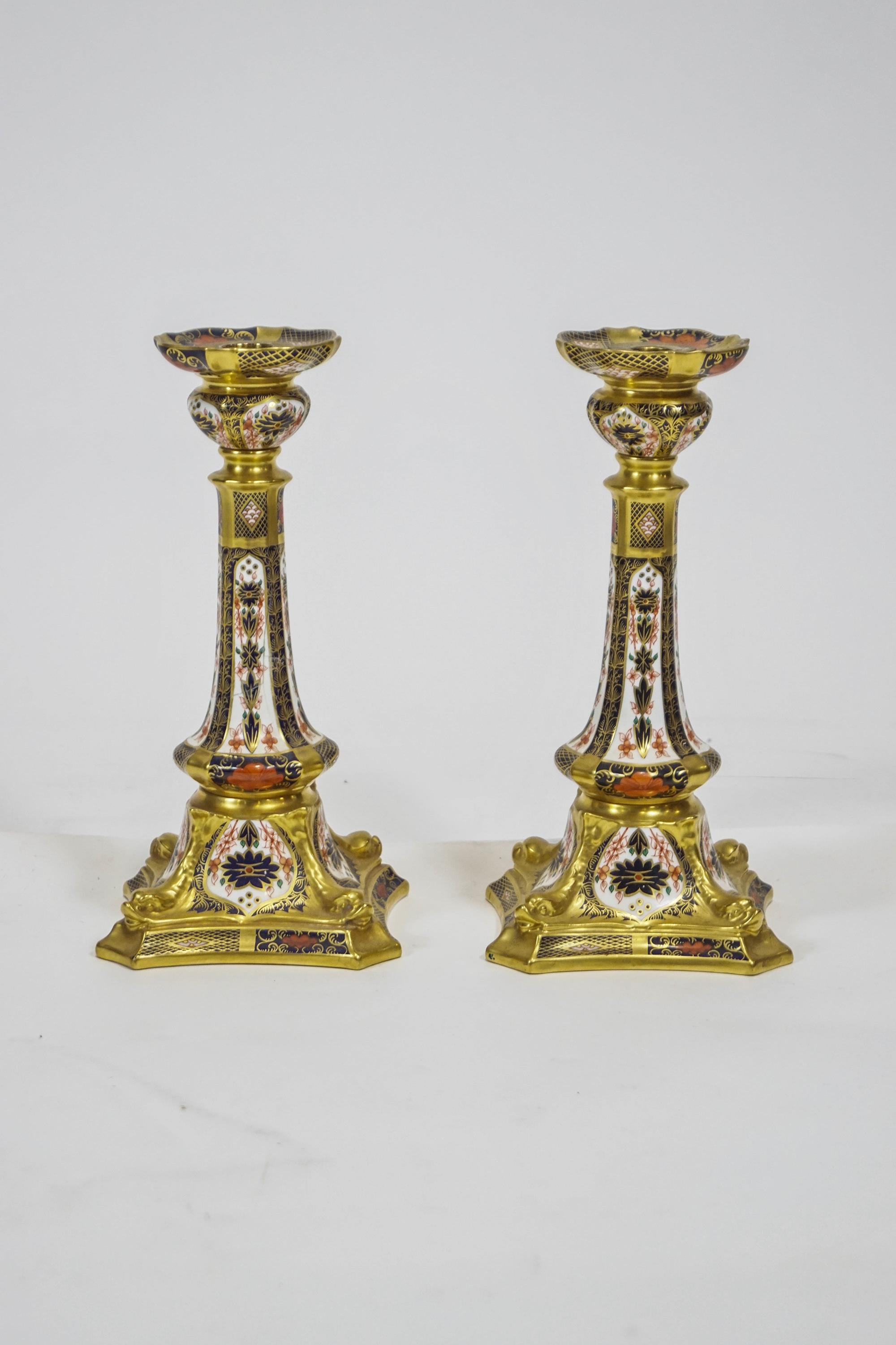 A pair of Royal Crown Derby solid gold band Imari candlesticks,