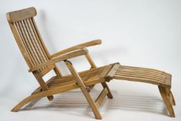 A non-matching pair of teak steamer chairs and cushions,
