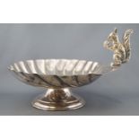An electroplated nut dish in the form of a large scallop shell,