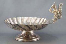 An electroplated nut dish in the form of a large scallop shell,