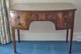 A 19th century mahogany bow fronted dressing table with five drawers on square tapering legs,