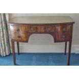 A 19th century mahogany bow fronted dressing table with five drawers on square tapering legs,