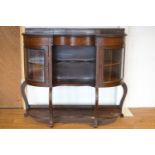 An Edwardian mahogany display cabinet with serpentine front,