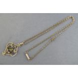 An Edwardian yellow metal pendant set with peridot and seed pearls;