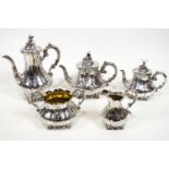 A silver five piece Rococo decorated lobed melon form tea and coffee service,