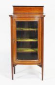 An Edwardian mahogany display cabinet with glazed bow front, set satinwood stringing and edges,