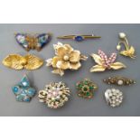 A collection of twenty costume brooches of variable designs.