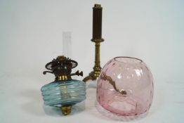 A Victorian oil lamp with blue glass reservoir and pink glass shade,