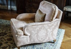 A late 19th century armchair on square tapering burr walnut legs with brass casters,