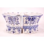 A pair of Delft flower bricks and a ginger jar, the bricks of lobed demi-lune form,