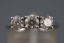 A white metal three stone ring.