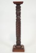 A carved mahogany torchere,