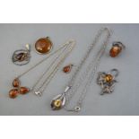 A collection of gem set white metal jewellery to include two necklaces, four pendants and a ring.