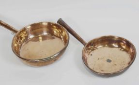 Two 19th century copper frying pans, of large form, both with hollow tapered handles,