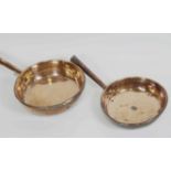 Two 19th century copper frying pans, of large form, both with hollow tapered handles,