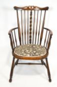 A late 19th century stained hardwood Arts and Crafts armchair with pierced carved and shaped splat