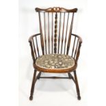 A late 19th century stained hardwood Arts and Crafts armchair with pierced carved and shaped splat