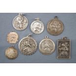 A collection of eight white metal St Christopher pendants. Most marked silver or 925.